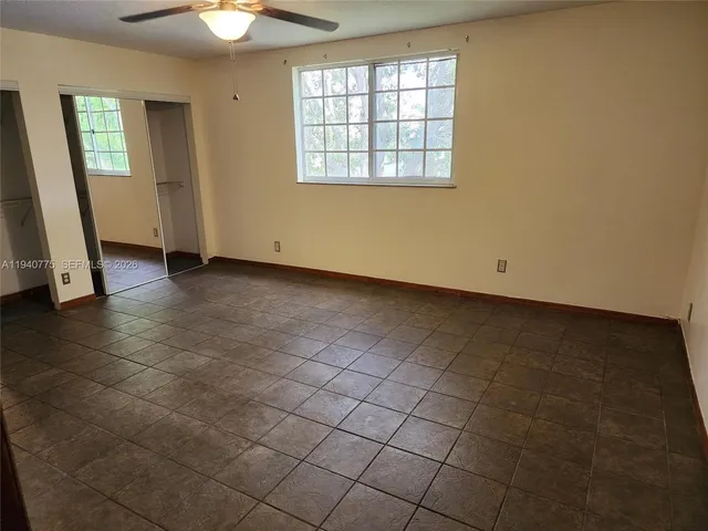 an empty room with a fireplace and painted walls