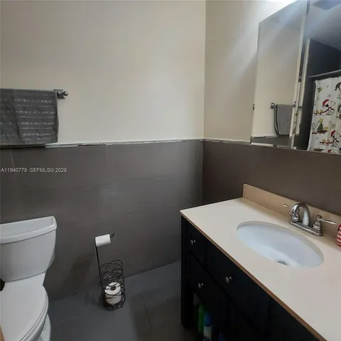 a bathroom with a sink toilet and a mirror