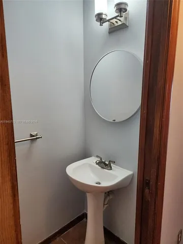 a bathroom with a sink and mirror
