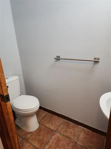 a white toilet sitting next to a small bathroom