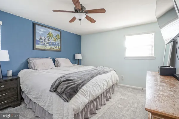 a bedroom with bed and a window