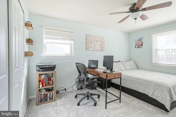 a bedroom with a bed and a workspace