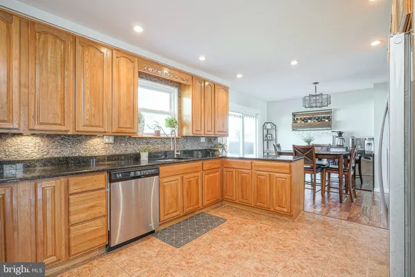 a kitchen with granite countertop sink cabinets and stainless steel appliances