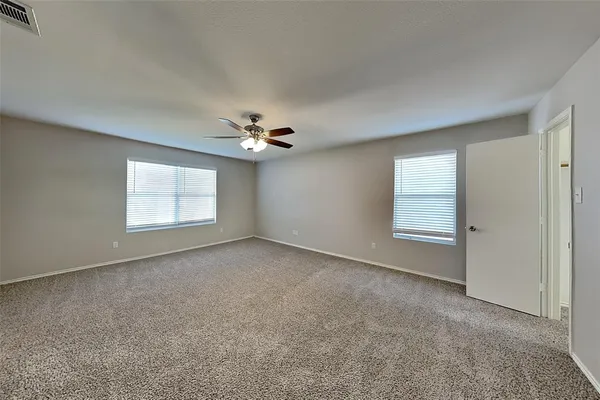 a view of a livingroom with a ceiling fan and window
