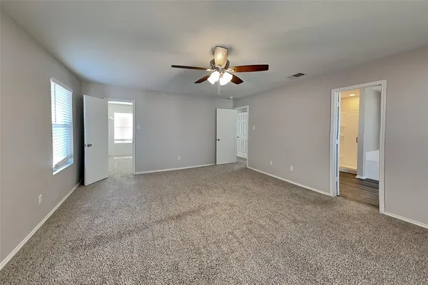 a bathroom with a bathtub and a window