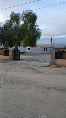 a view of a house with a yard and large trees
