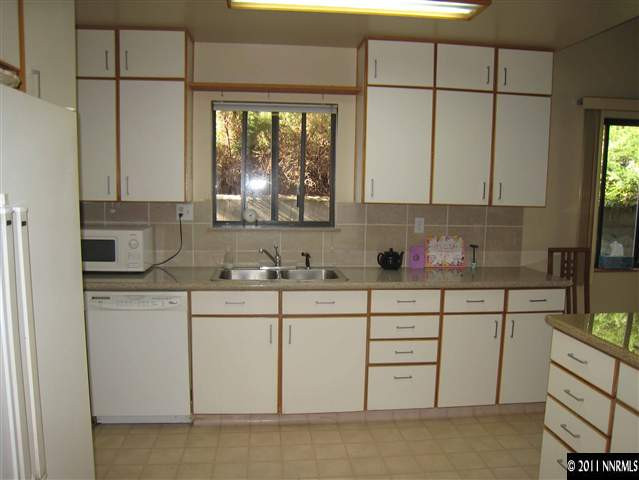 1750 O Farrell Street Reno, NV 89503 - Photo 3 of 13 a kitchen with stainless steel appliances granite countertop a sink a stove and a refrigerator
