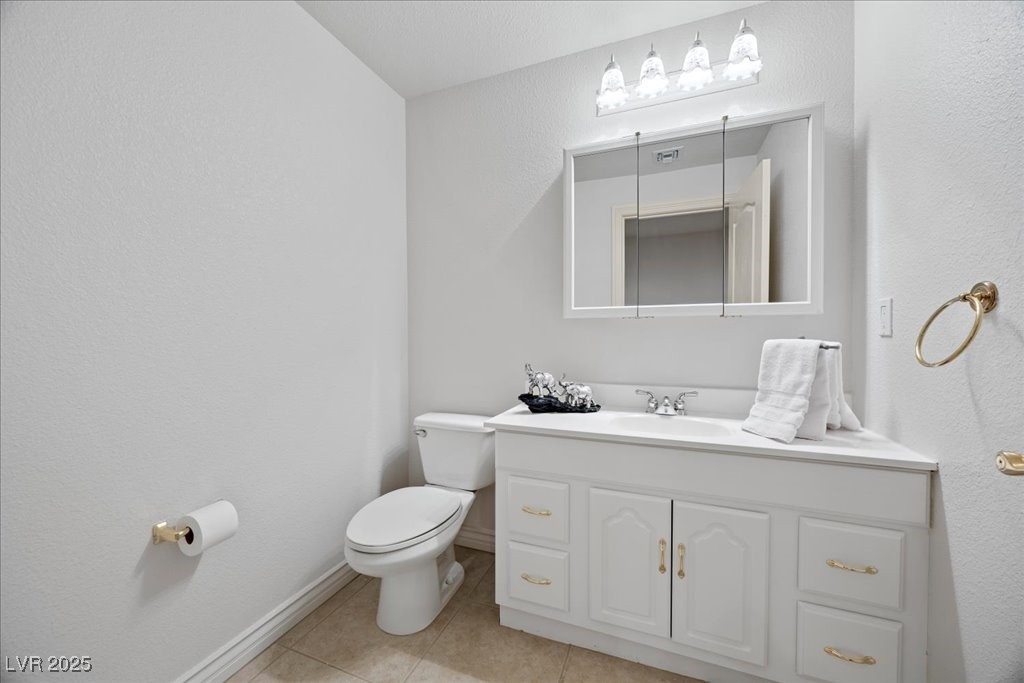 640 Quail Covey Road Henderson, NV 89002 - Photo 11 of 75 Half bath with tile patterned flooring and vanity in Basement