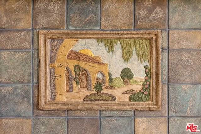 a table with chairs and a vase of flowers