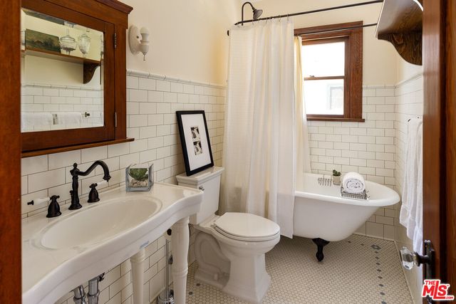 a bedroom with a bed and a large window with the outer view