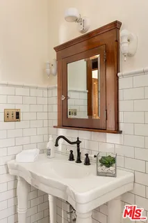 a kitchen with granite countertop a sink and a refrigerator