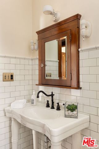 a kitchen with granite countertop a sink and a refrigerator