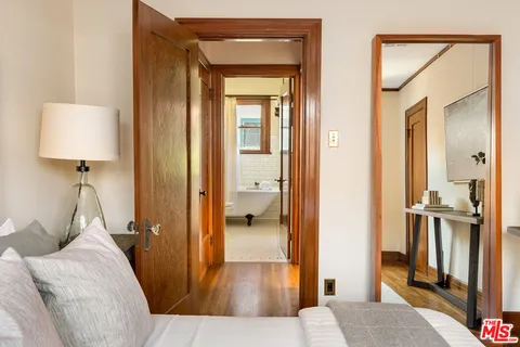 a kitchen with a sink a stove cabinets and a wooden floor