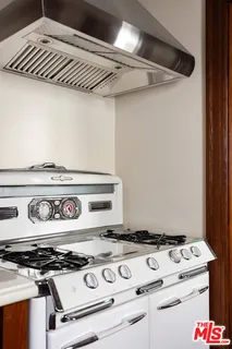 a kitchen view with a fireplace and wooden floor