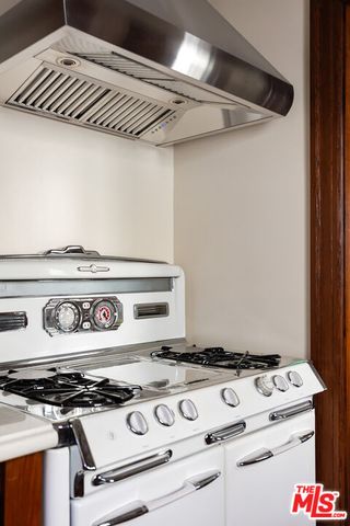 a kitchen view with a fireplace and wooden floor