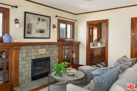 a living room with a table and chairs