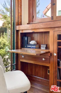 a view of a house with a yard and potted plants