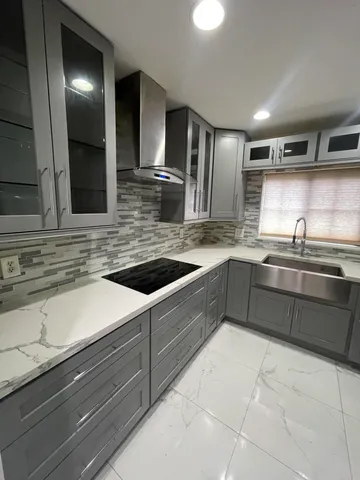 a kitchen with stainless steel appliances granite countertop a sink and a stove