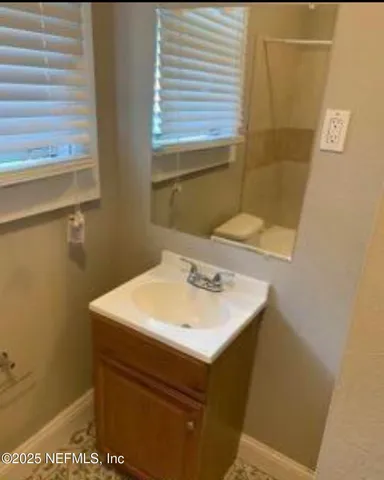a bathroom with a sink a mirror and a toilet