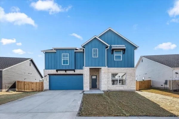 a view of a house with a patio and a yard