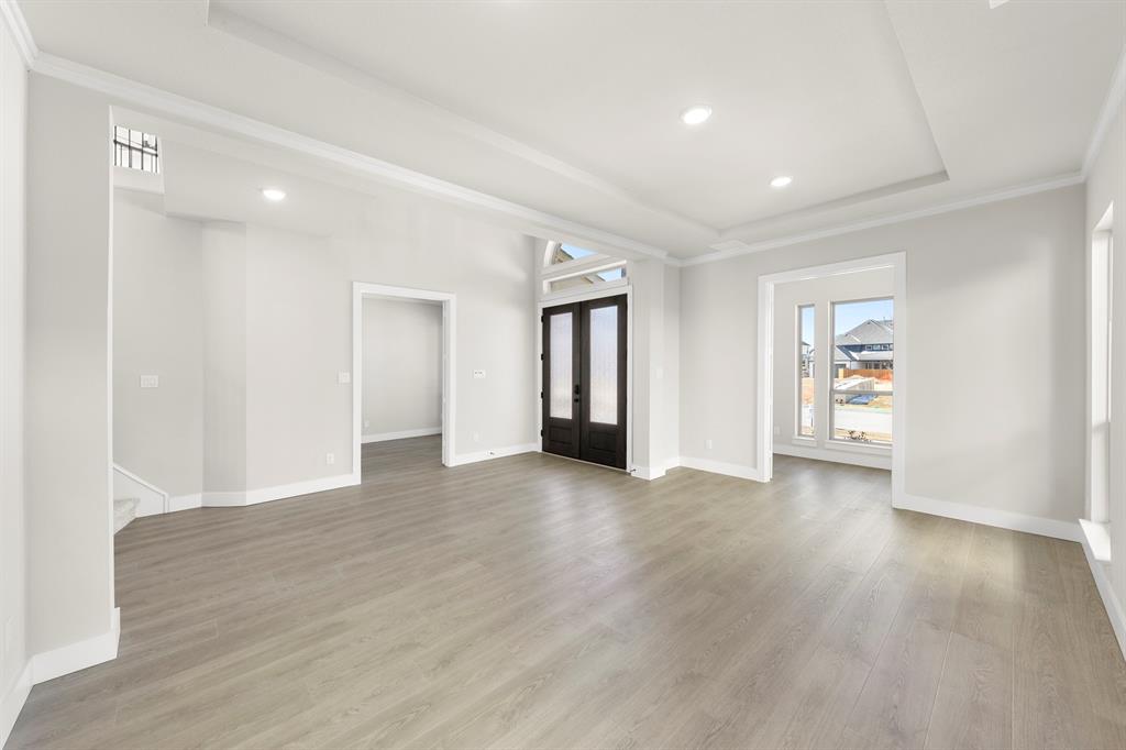 14994 Chipping Trail Frisco, TX 75035 - Photo 11 of 40 a view of an empty room with wooden floor and windows