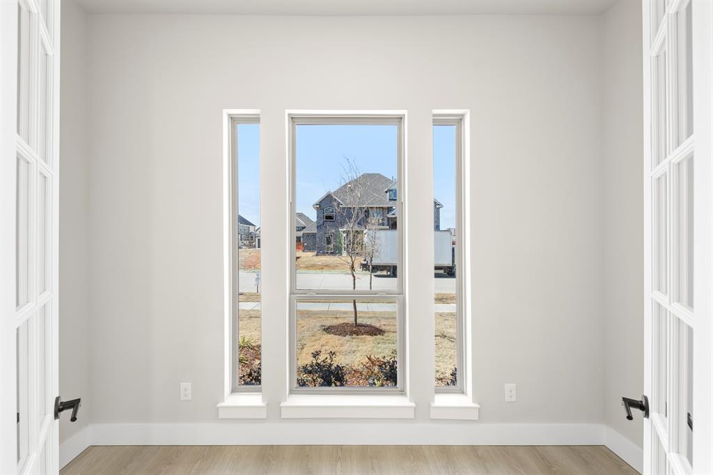 14994 Chipping Trail Frisco, TX 75035 - Photo 12 of 40 a view of a hallway with wooden floor and dining room view