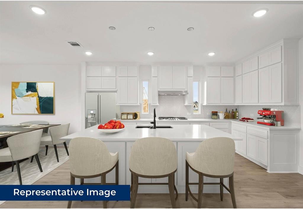14994 Chipping Trail Frisco, TX 75035 - Photo 15 of 40 a kitchen with stainless steel appliances kitchen island granite countertop a dining table chairs and sink
