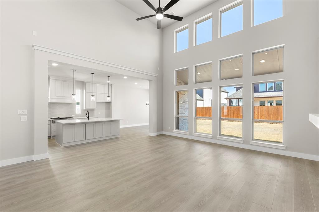 14994 Chipping Trail Frisco, TX 75035 - Photo 16 of 40 a large white kitchen with granite countertop a large window and white cabinets