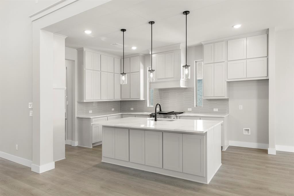 14994 Chipping Trail Frisco, TX 75035 - Photo 21 of 40 a kitchen with kitchen island a sink stainless steel appliances and cabinets