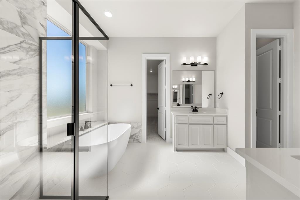 14994 Chipping Trail Frisco, TX 75035 - Photo 26 of 40 a bathroom with a granite countertop sink mirror and bathtub