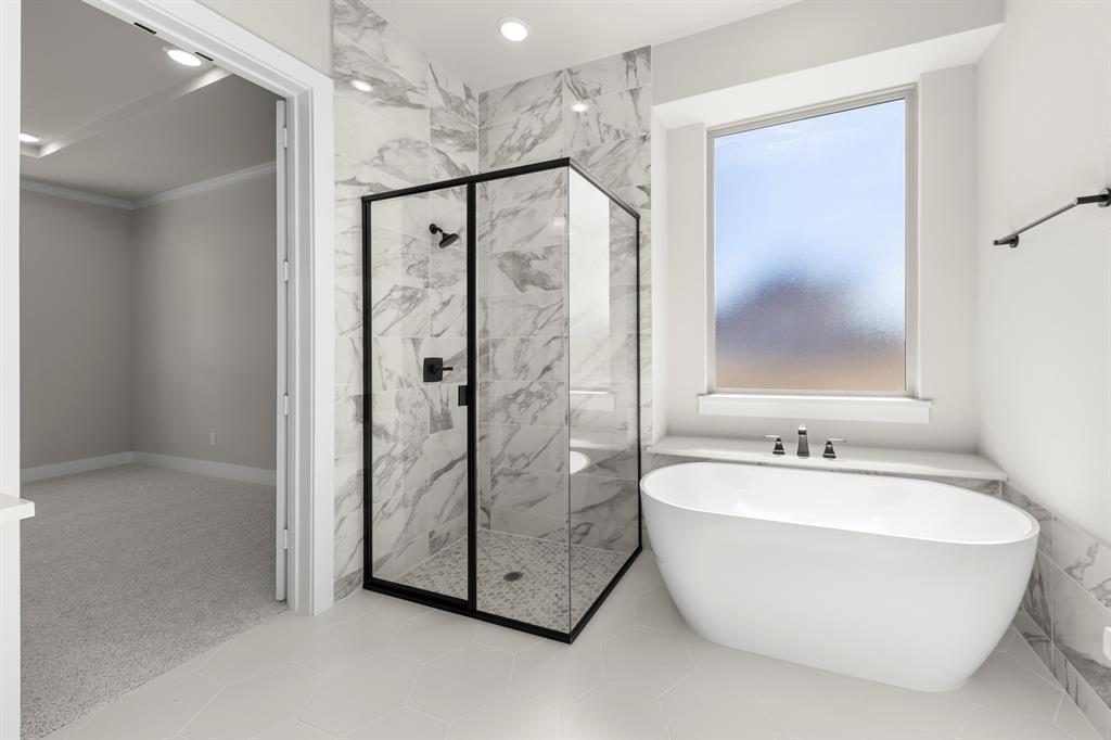14994 Chipping Trail Frisco, TX 75035 - Photo 27 of 40 a bathroom with a bathtub and a shower