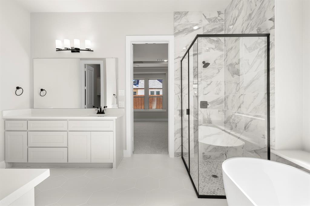 14994 Chipping Trail Frisco, TX 75035 - Photo 28 of 40 a bathroom with a sink a vanity and a mirror