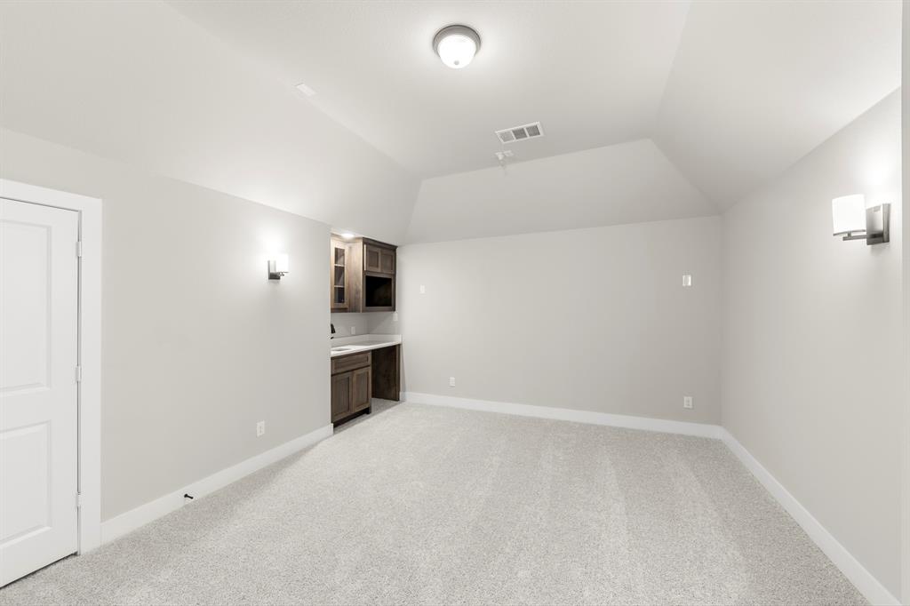 14994 Chipping Trail Frisco, TX 75035 - Photo 32 of 40 an empty room with a kitchen and a sink