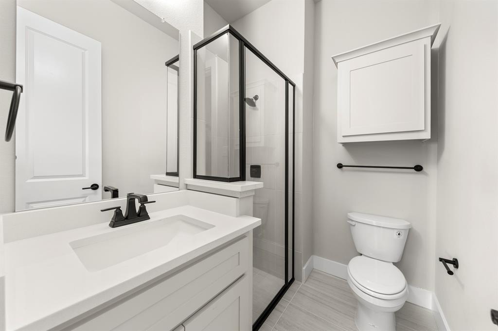 14994 Chipping Trail Frisco, TX 75035 - Photo 33 of 40 a bathroom with a sink a toilet and a mirror