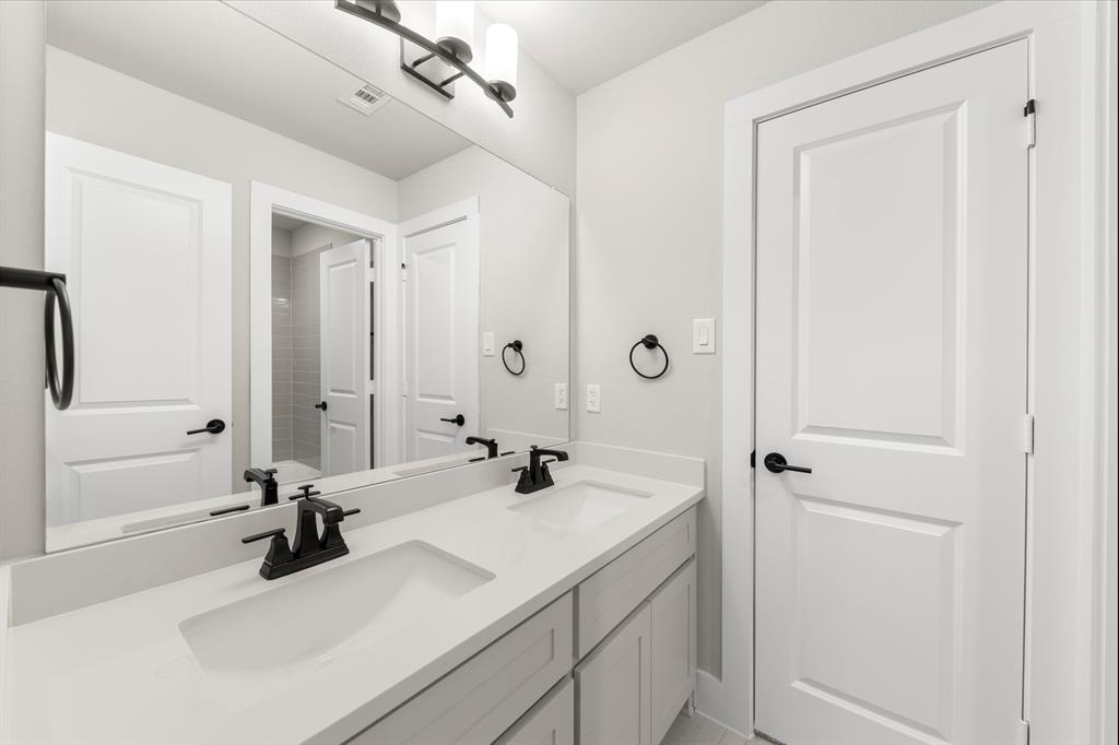14994 Chipping Trail Frisco, TX 75035 - Photo 34 of 40 a bathroom with a sink and a mirror