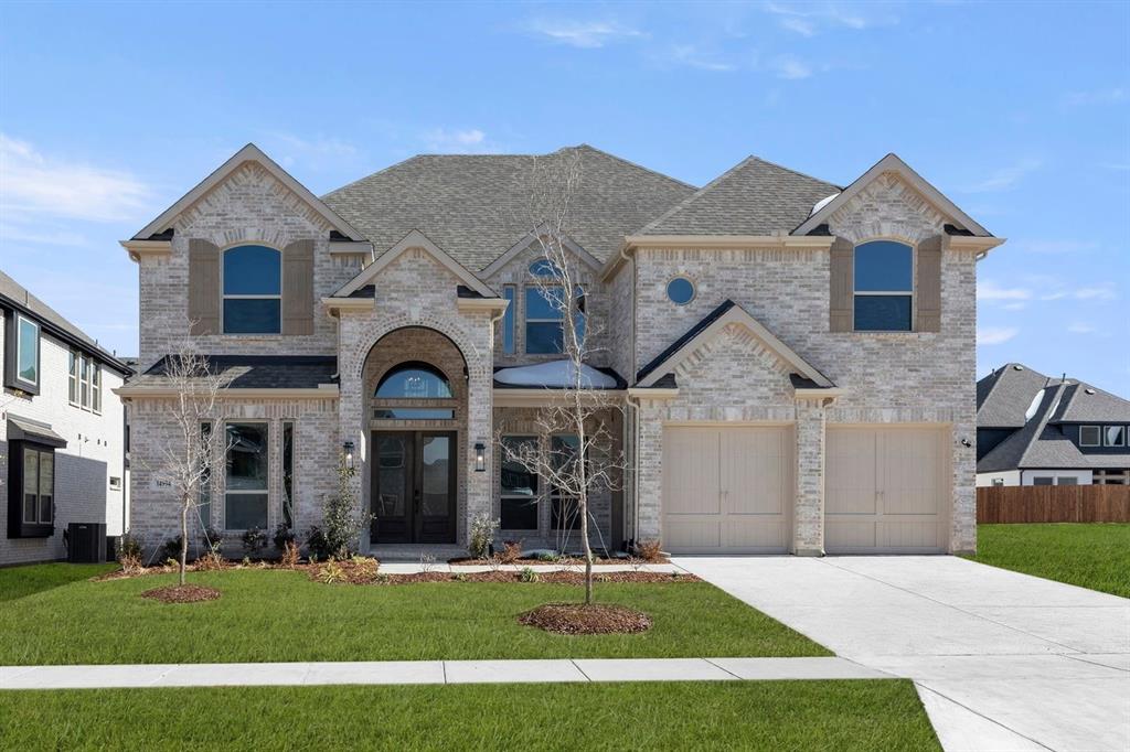 14994 Chipping Trail Frisco, TX 75035 - Photo 4 of 40 a front view of a house with a yard