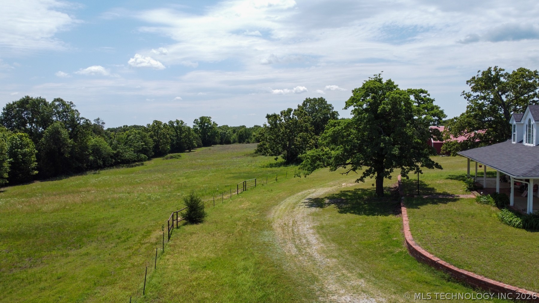 Expansive green pasture with a tree line border