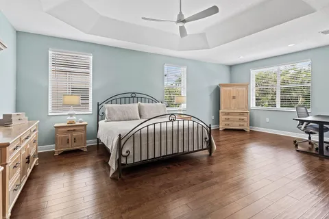 a bedroom with a bed and a large window