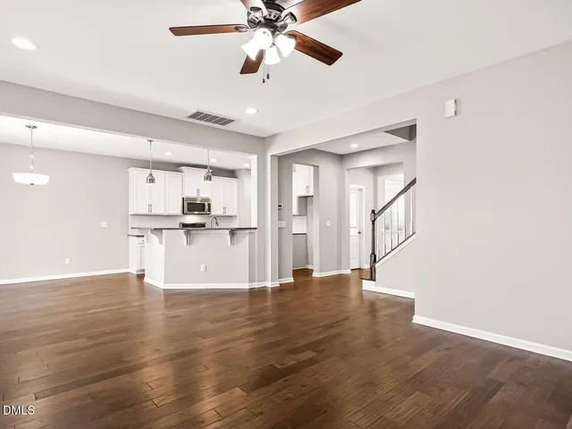 a view of kitchen with granite countertop cabinets and refrigerator