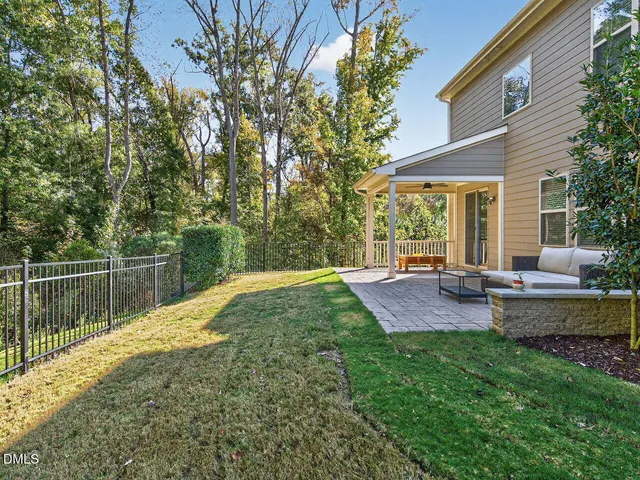 a view of a house with a backyard and a patio