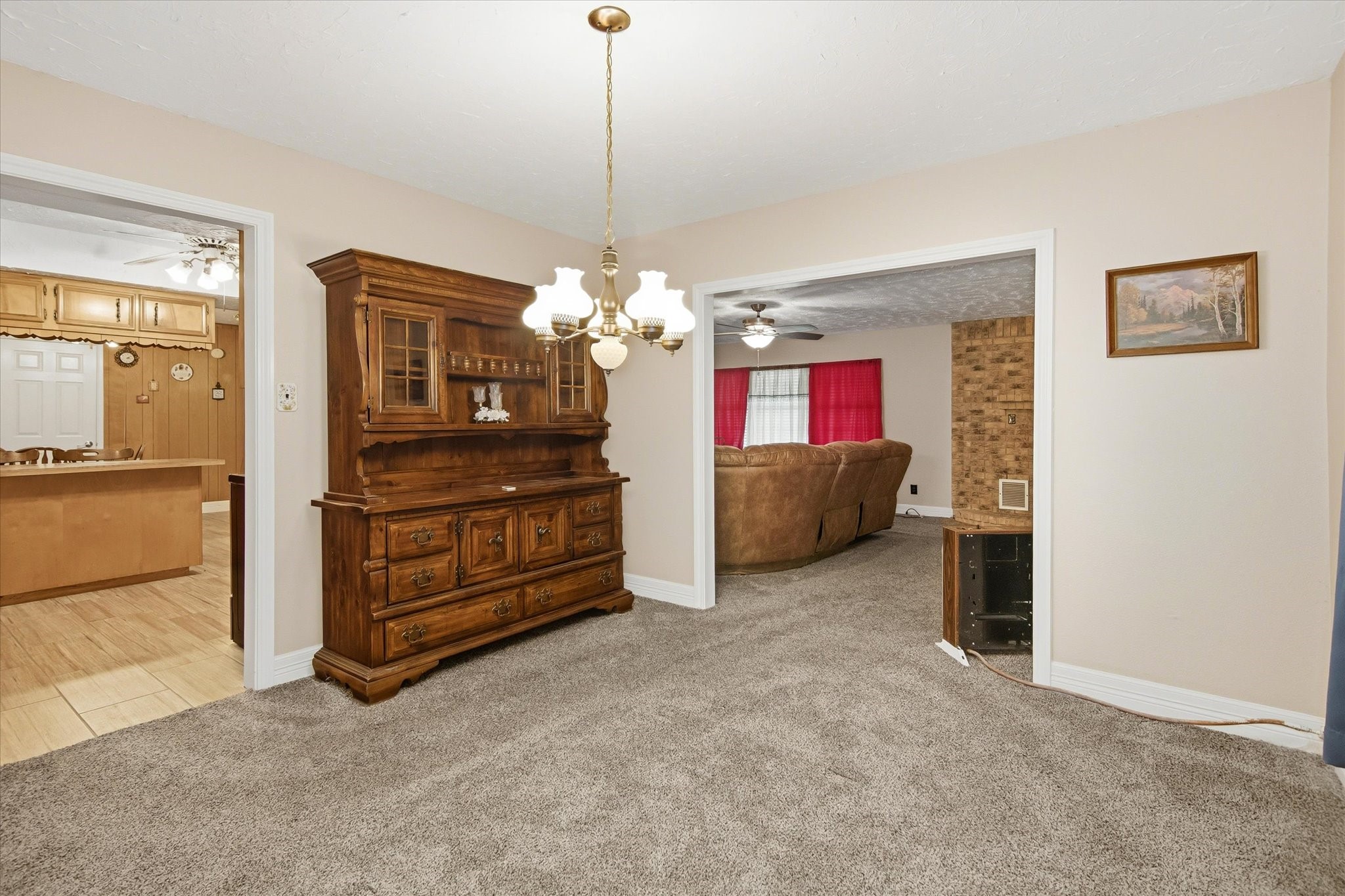 411 County Road 2298 Cleveland, TX 77327 - Photo 11 of 47 a living room with furniture and a chandelier