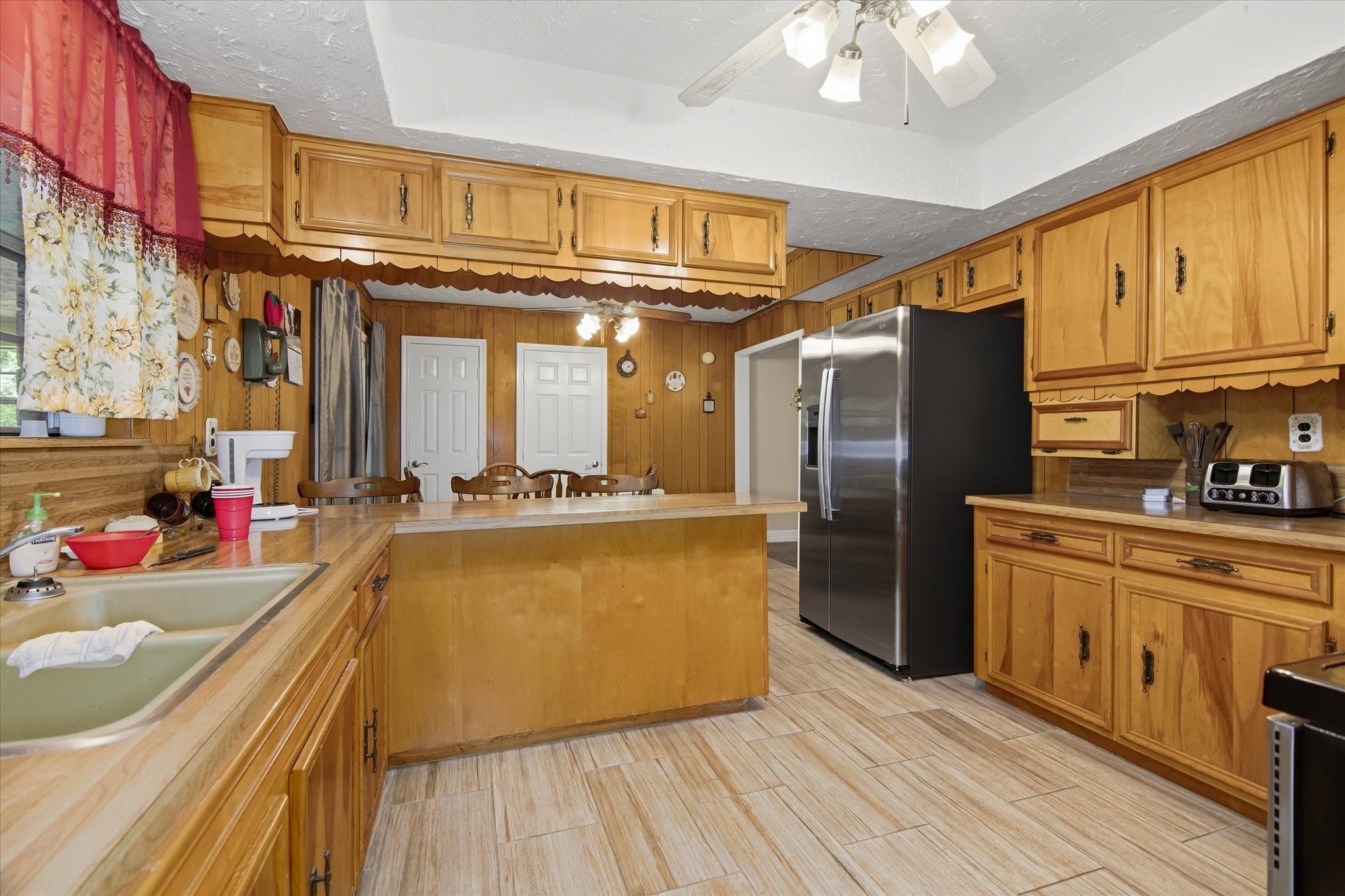 411 County Road 2298 Cleveland, TX 77327 - Photo 13 of 47 a kitchen with stainless steel appliances granite countertop a refrigerator a stove and a wooden floors