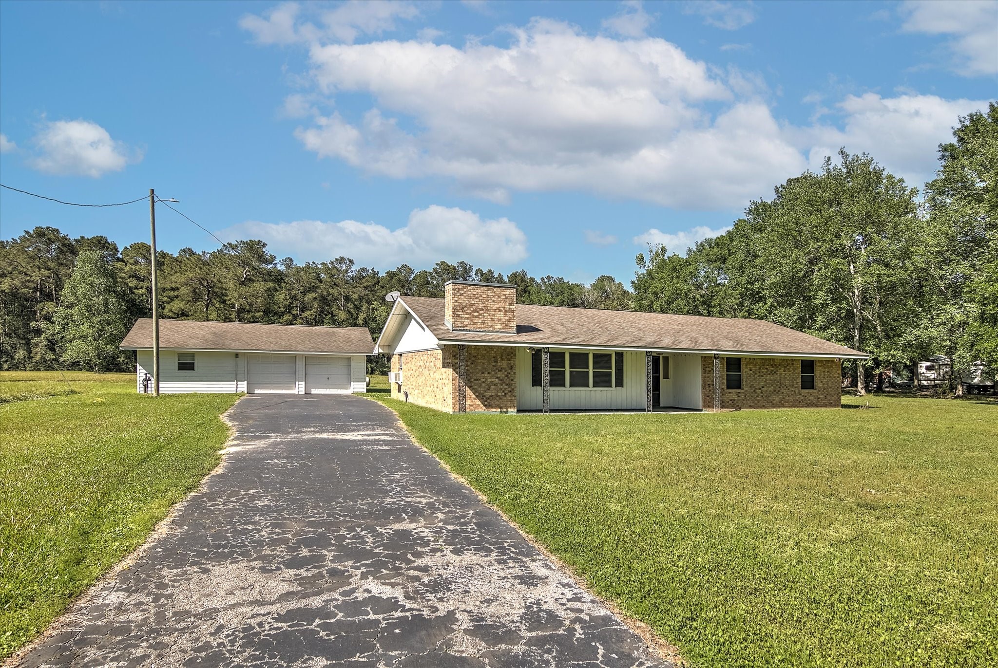411 County Road 2298 Cleveland, TX 77327 - Photo 2 of 47 a front view of a house with a yard