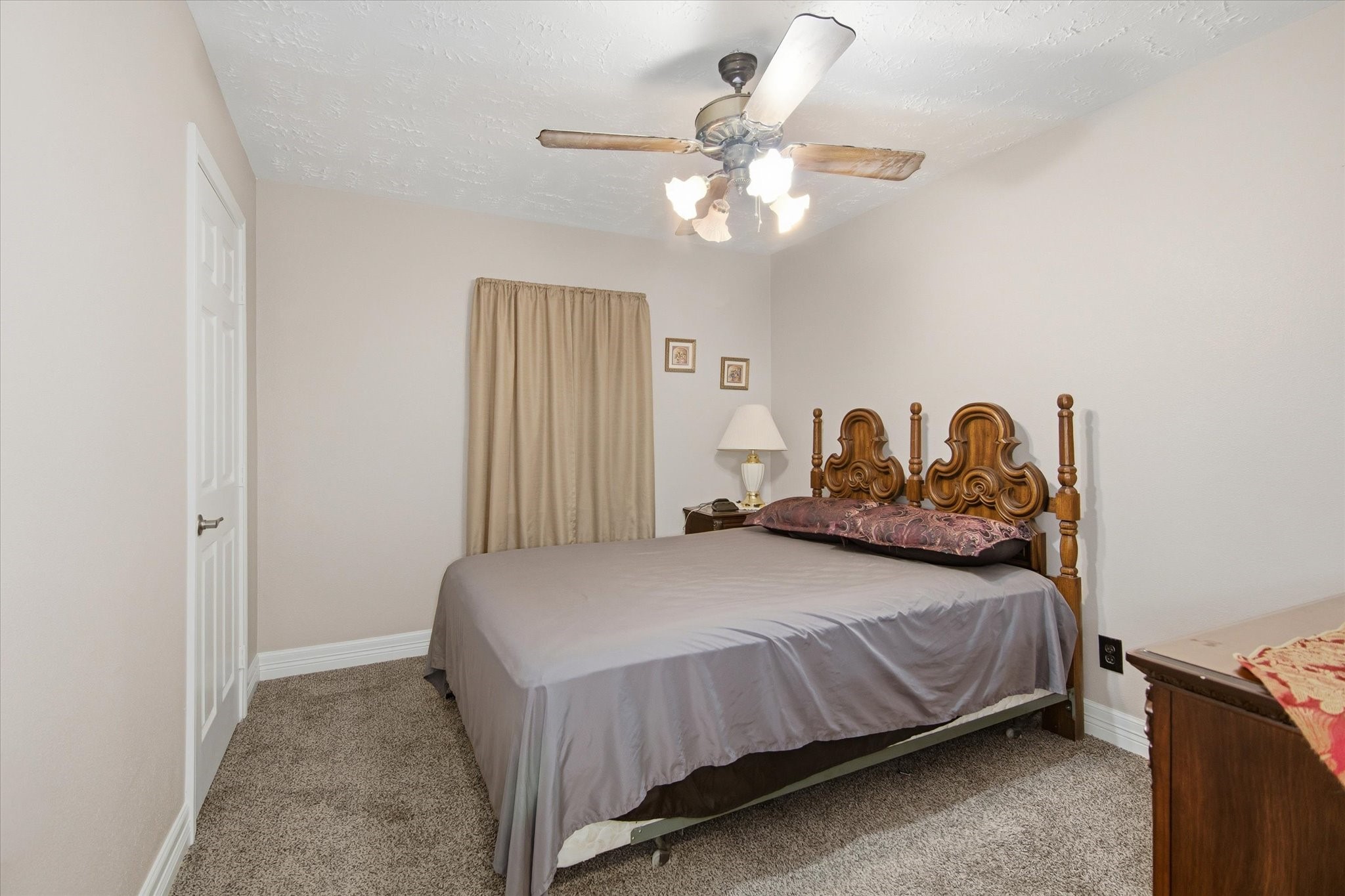 411 County Road 2298 Cleveland, TX 77327 - Photo 22 of 47 a bedroom with a bed and a chandelier