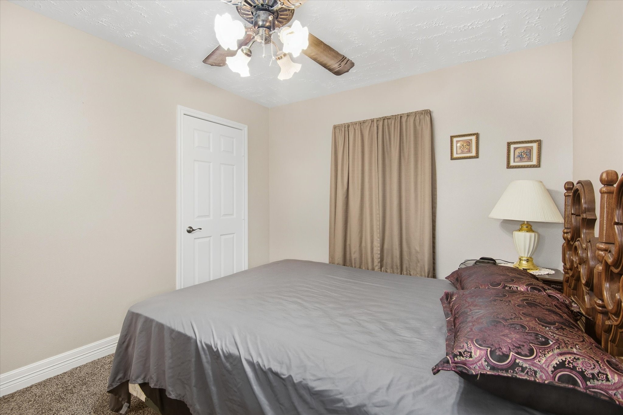411 County Road 2298 Cleveland, TX 77327 - Photo 23 of 47 a bedroom with a bed and a chandelier
