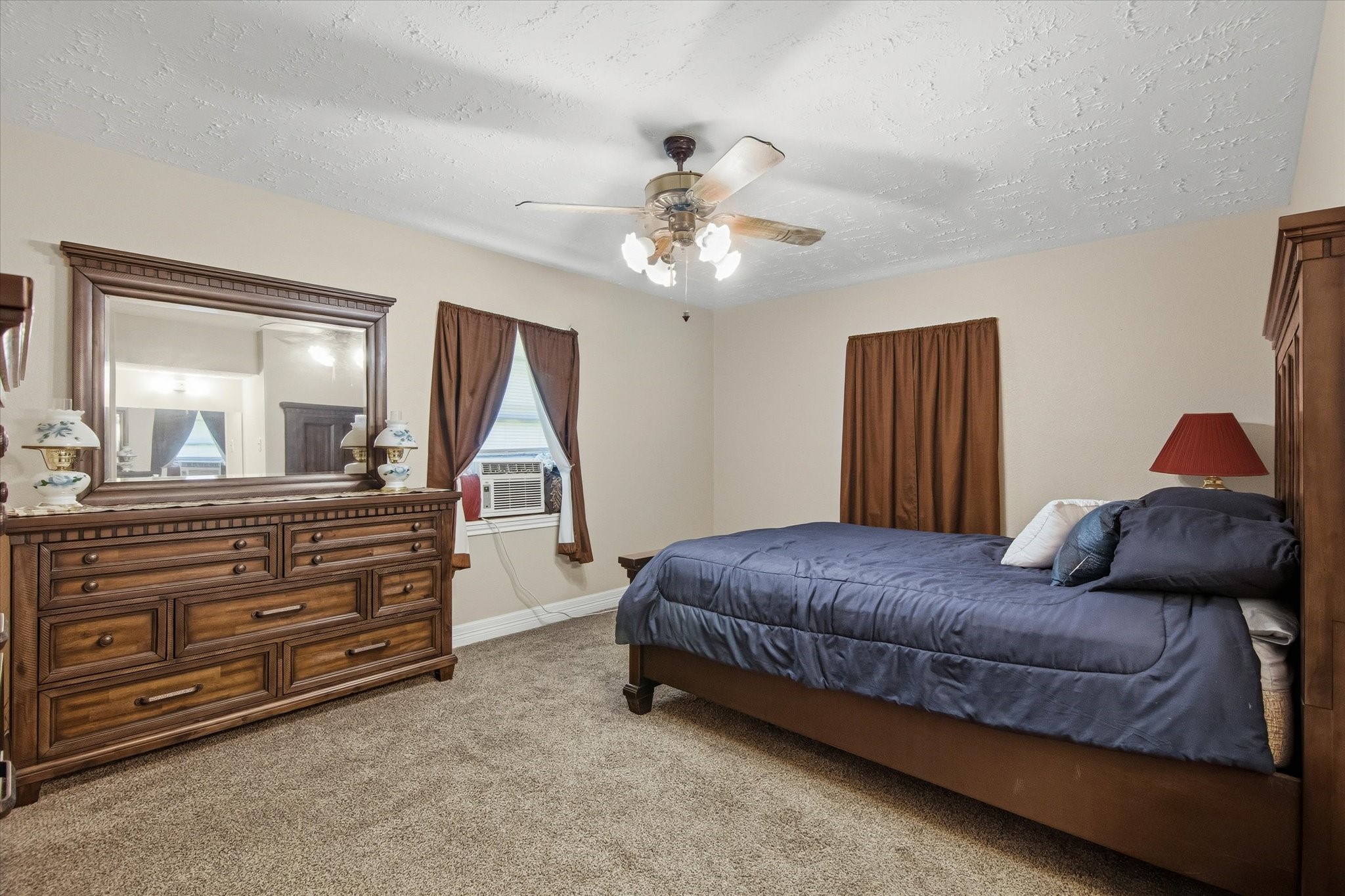 411 County Road 2298 Cleveland, TX 77327 - Photo 24 of 47 a living room with a bed and a chandelier