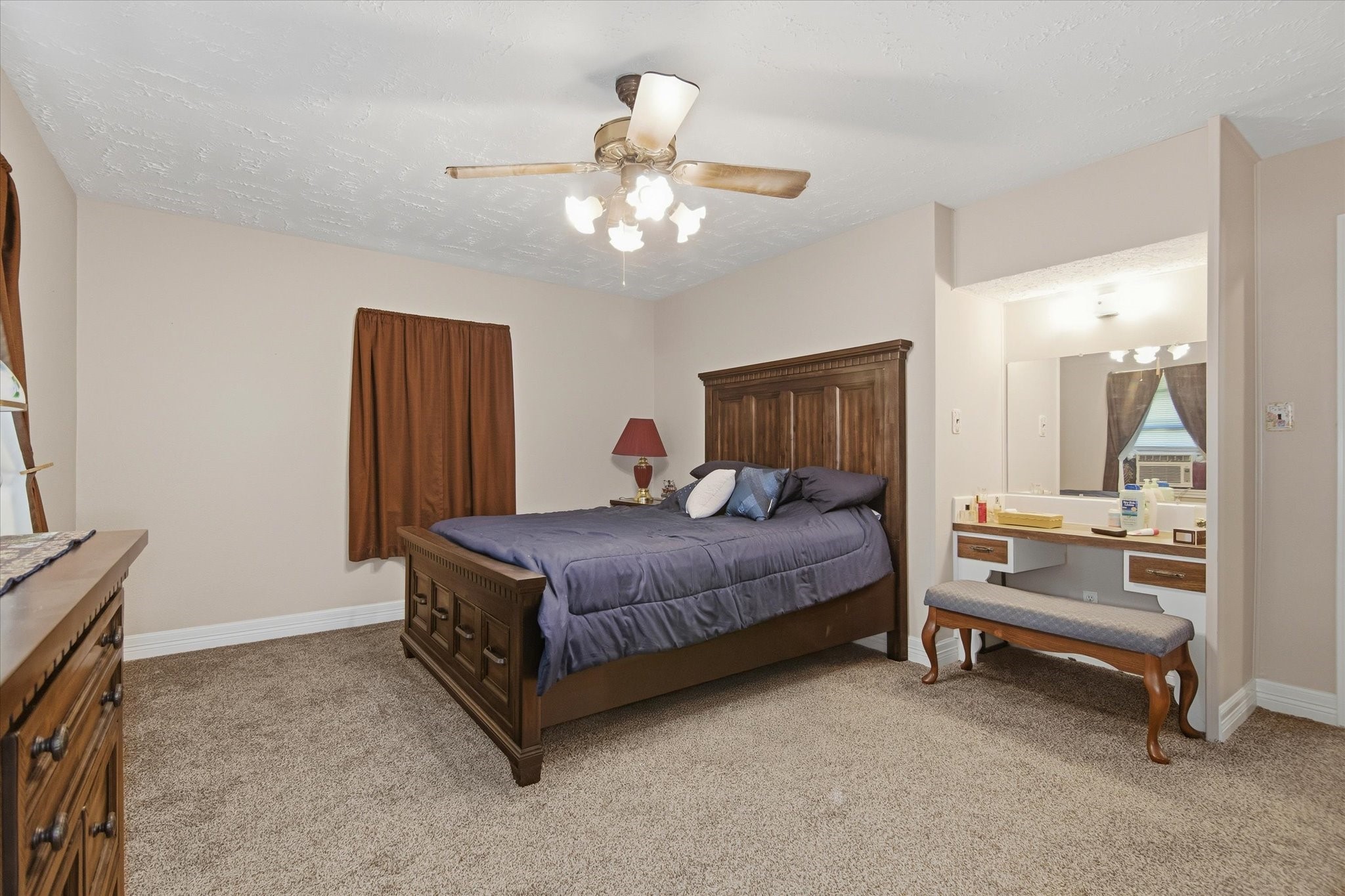 411 County Road 2298 Cleveland, TX 77327 - Photo 25 of 47 a bedroom with a bed and a chandelier