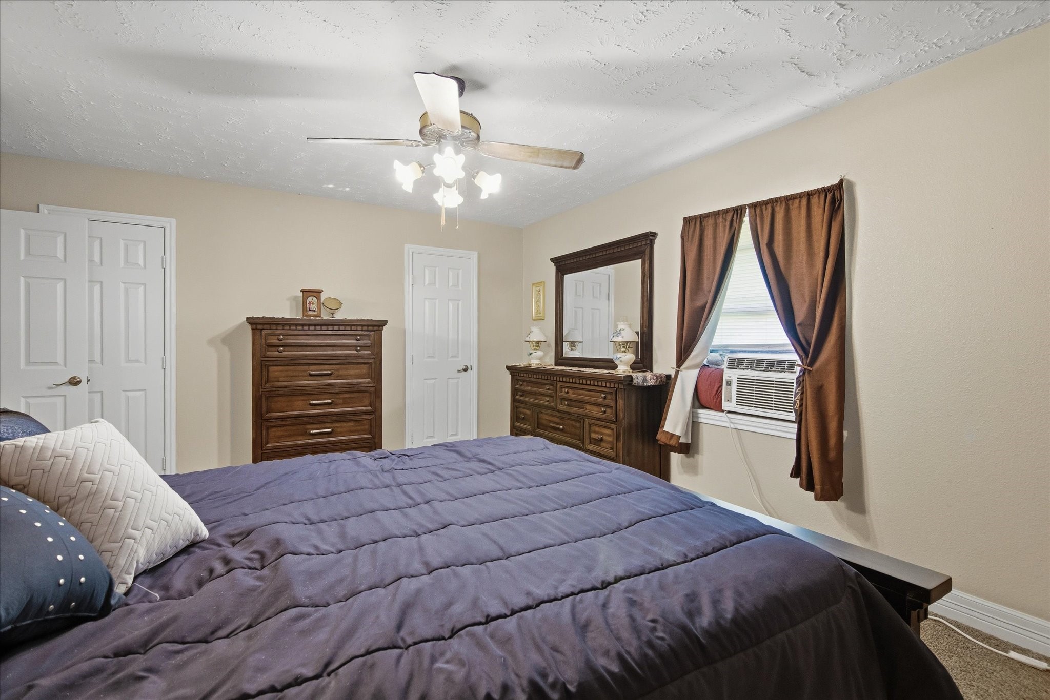 411 County Road 2298 Cleveland, TX 77327 - Photo 27 of 47 a bedroom with a large bed and a window