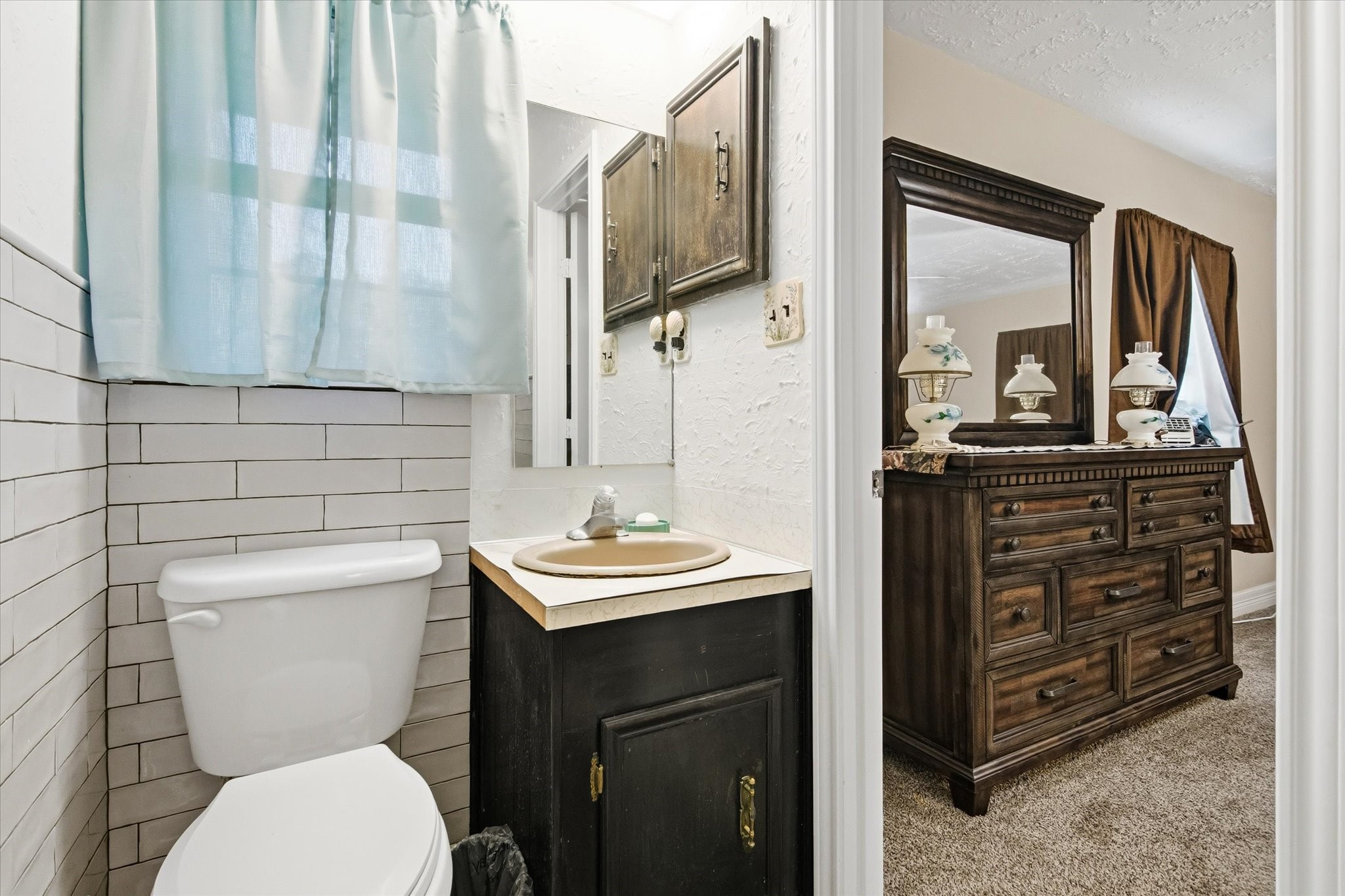 411 County Road 2298 Cleveland, TX 77327 - Photo 28 of 47 a bathroom with a toilet a sink and mirror