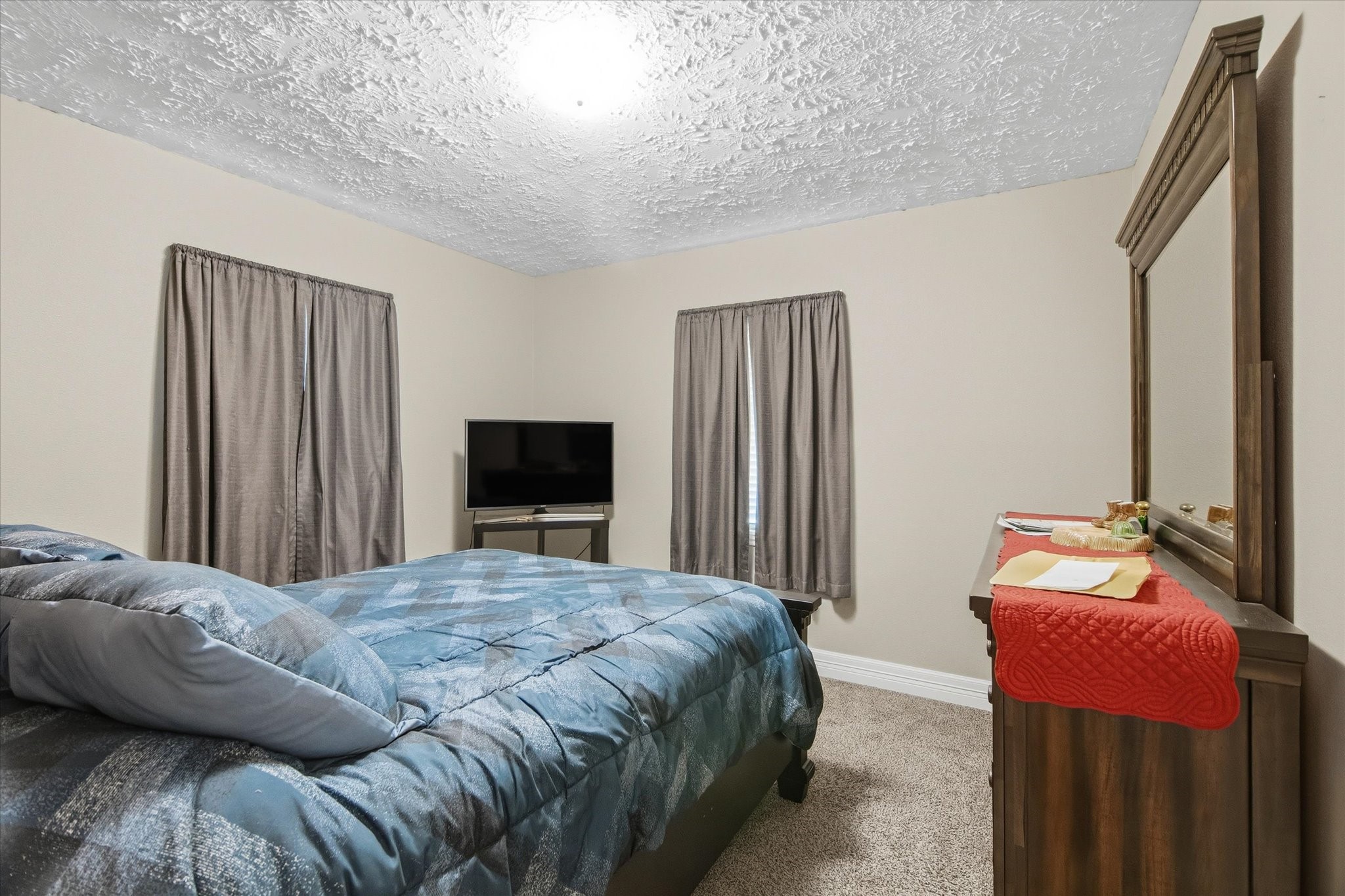 411 County Road 2298 Cleveland, TX 77327 - Photo 30 of 47 a bedroom with a bed and a television
